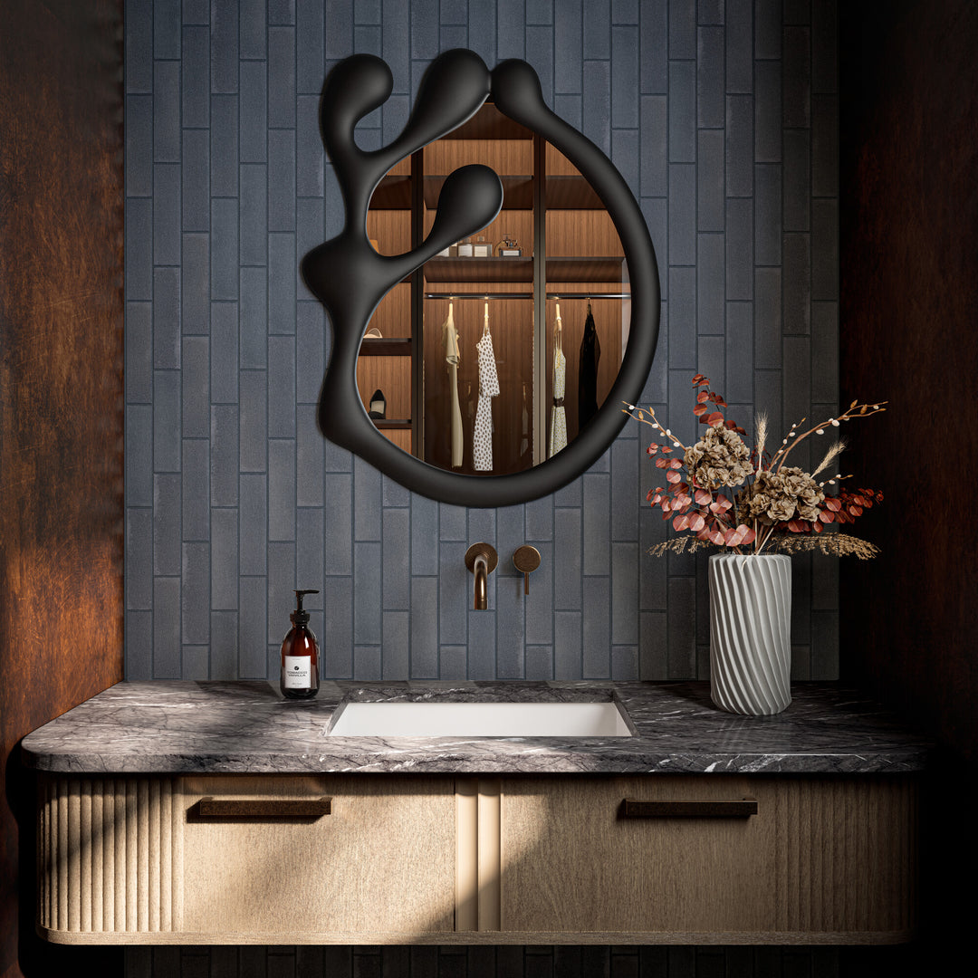 In this styled space, Inyo Indigo 2x8 satin glazed ceramic tile introduces deep color and a soft, velvety sheen with a modern rectangular layout.