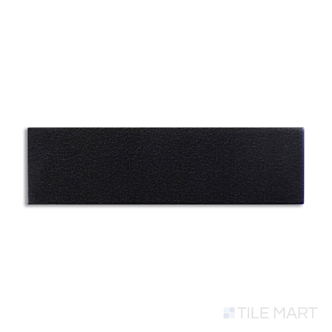 Diagonal view of Inyo Ink 2x8 satin glazed ceramic tile, showcasing a bold ink-black color, a soft satin texture, and a modern elongated shape.  