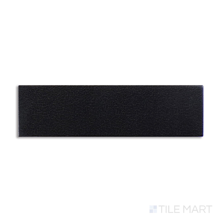 Diagonal view of Inyo Ink 2x8 satin glazed ceramic tile, showcasing a bold ink-black color, a soft satin texture, and a modern elongated shape.  
