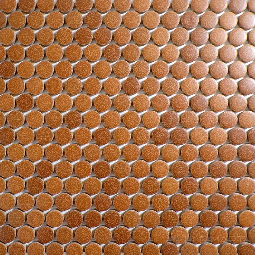 Top-down view of Inyo Ember Penny Round Matte Glazed Ceramic Mosaic, showcasing its warm color in a timeless mosaic design.