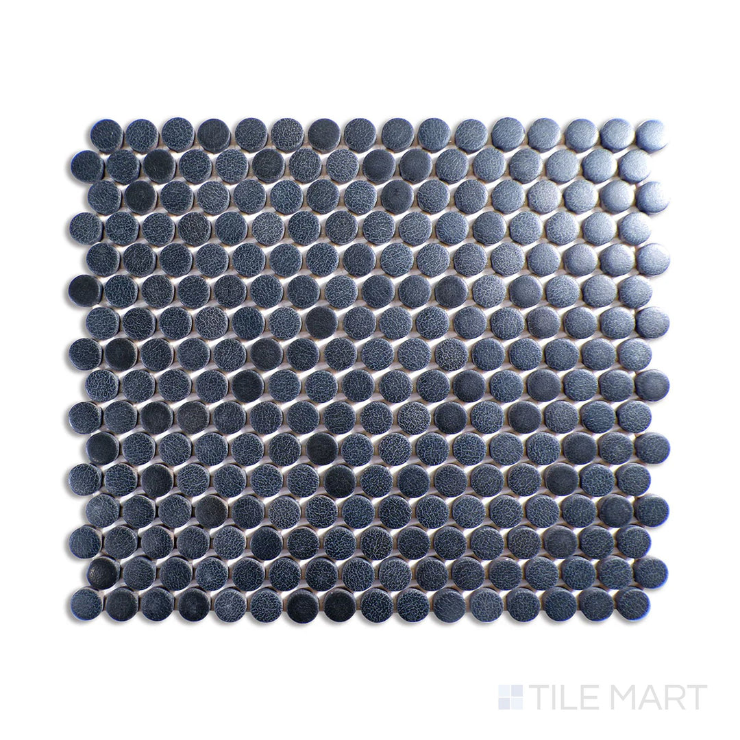 Angled shot of Inyo Indigo penny round matte glazed ceramic mosaic, featuring a deep blue indigo shade, a sleek matte surface, and a penny round mosaic pattern.  