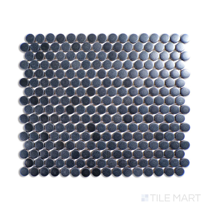 Angled shot of Inyo Indigo penny round matte glazed ceramic mosaic, featuring a deep blue indigo shade, a sleek matte surface, and a penny round mosaic pattern.  