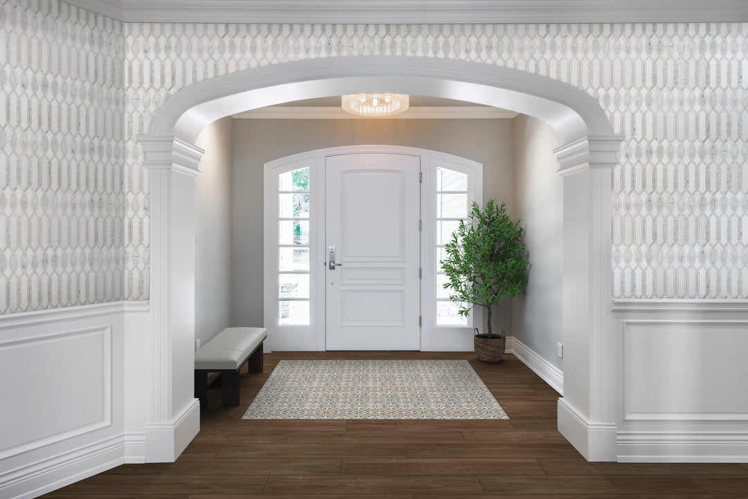 Installed in a real-life interior, the Lavaliere Carrara, Thassos, and mother of pearl Imaginare polished mosaic creates a luminous, layered stone look