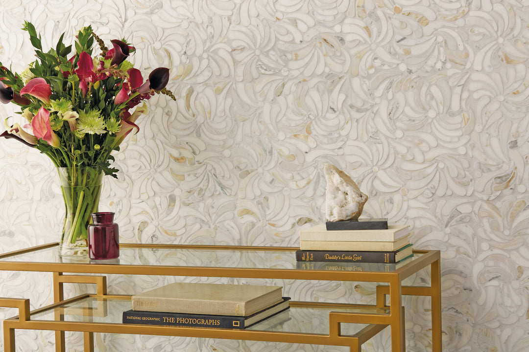 Shown in a finished space, the Lavaliere Calacatta Gold Windblown honed mosaic brings natural movement and warm veining to the room