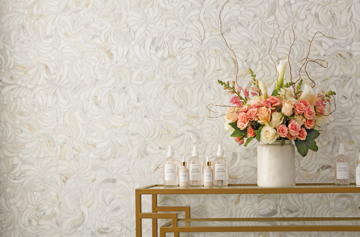 Lavaliere Calacatta Gold Windblown honed mosaic tile displayed in an elegant setting, highlighting soft marble veining and a dynamic flowing pattern.