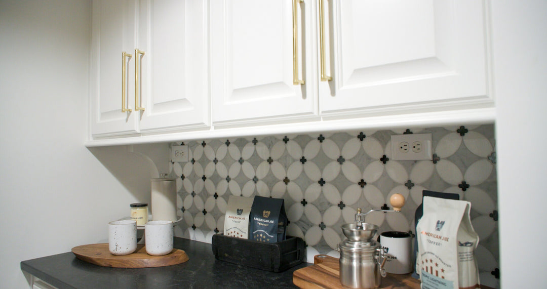 Crafted for visual impact, the Lavaliere Carrara/Thassos/Black Ant Mirror Petal honed mosaic tile layers fine marble tones with mirrored elements in a petal-inspired design.