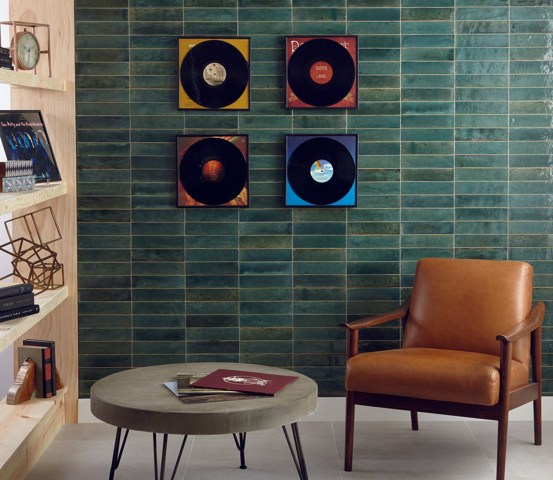 Shown in a finished interior, the Remedy Herbal 2x10 glossy glazed porcelain tile brings a calming tone and sleek linear format