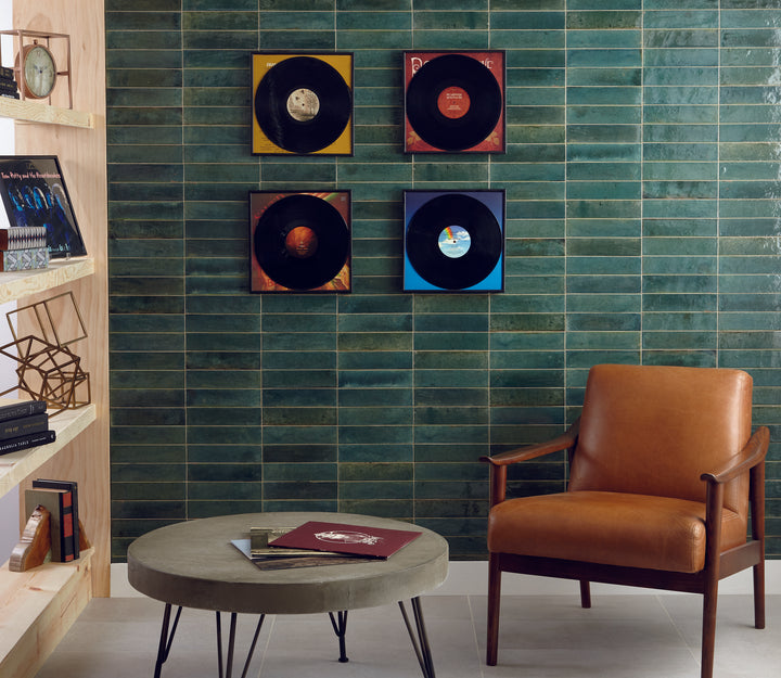 Shown in a finished interior, the Remedy Herbal 2x10 glossy glazed porcelain tile brings a calming tone and sleek linear format