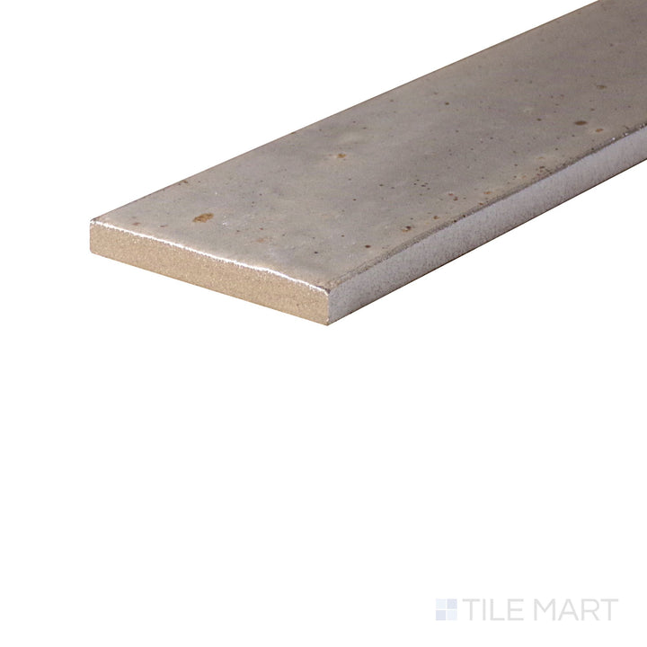 Remedy Zen 2x10 glossy glazed porcelain tile seen from the corner, capturing shine and elongated edge profile.