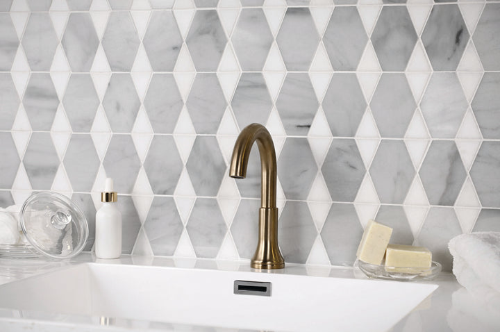 Shown in a finished space, the Perfit Mosaix Saran White and Thassos reverse polished mosaic brings a clean, luminous feel with layered marble detail