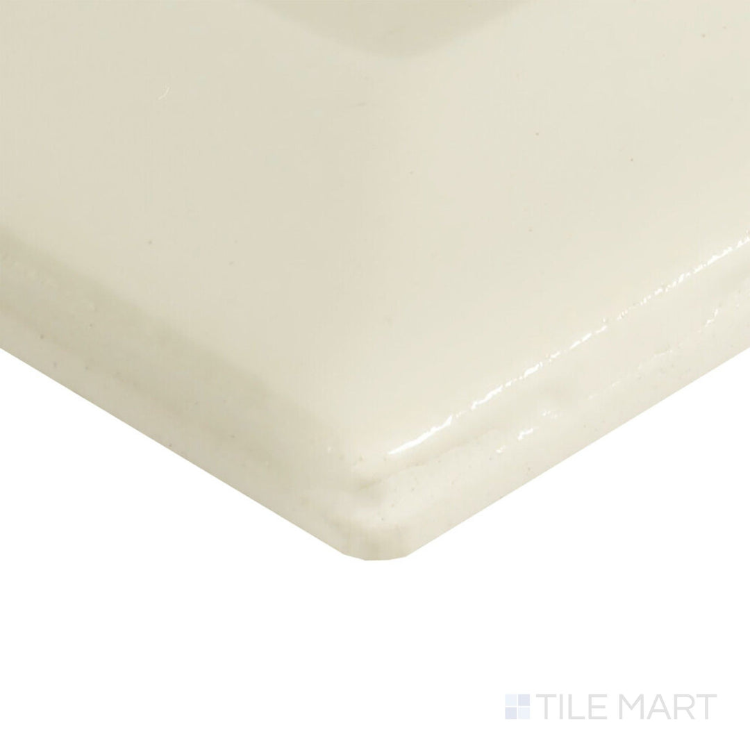 From a sharp corner angle, the Color Wheel Classic Almond 3x6 beveled glossy ceramic tile displays its warm neutral tone with subtle shine.