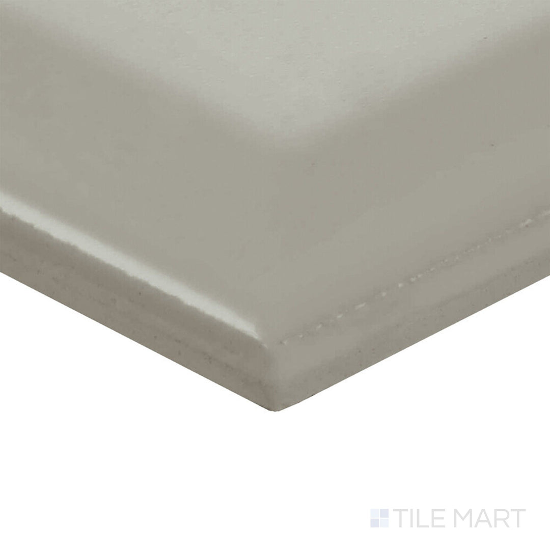 Presented at a corner angle, the Color Wheel Classic Desert Gray 3x6 beveled matte ceramic tile reveals its muted tone and smooth, low-sheen surface.