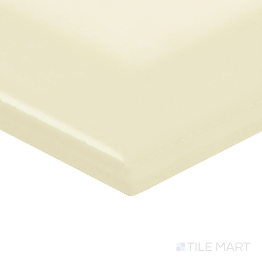 The Color Wheel Classic Almond 3x6 beveled matte glazed ceramic tile is shown in a corner shot, highlighting its creamy hue and gentle texture.