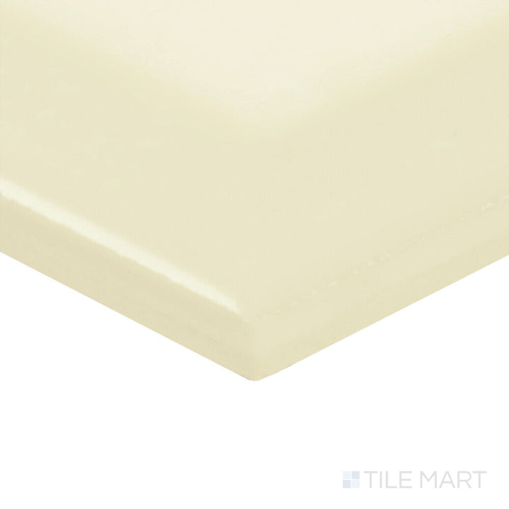 The Color Wheel Classic Almond 3x6 beveled matte glazed ceramic tile is shown in a corner shot, highlighting its creamy hue and gentle texture.