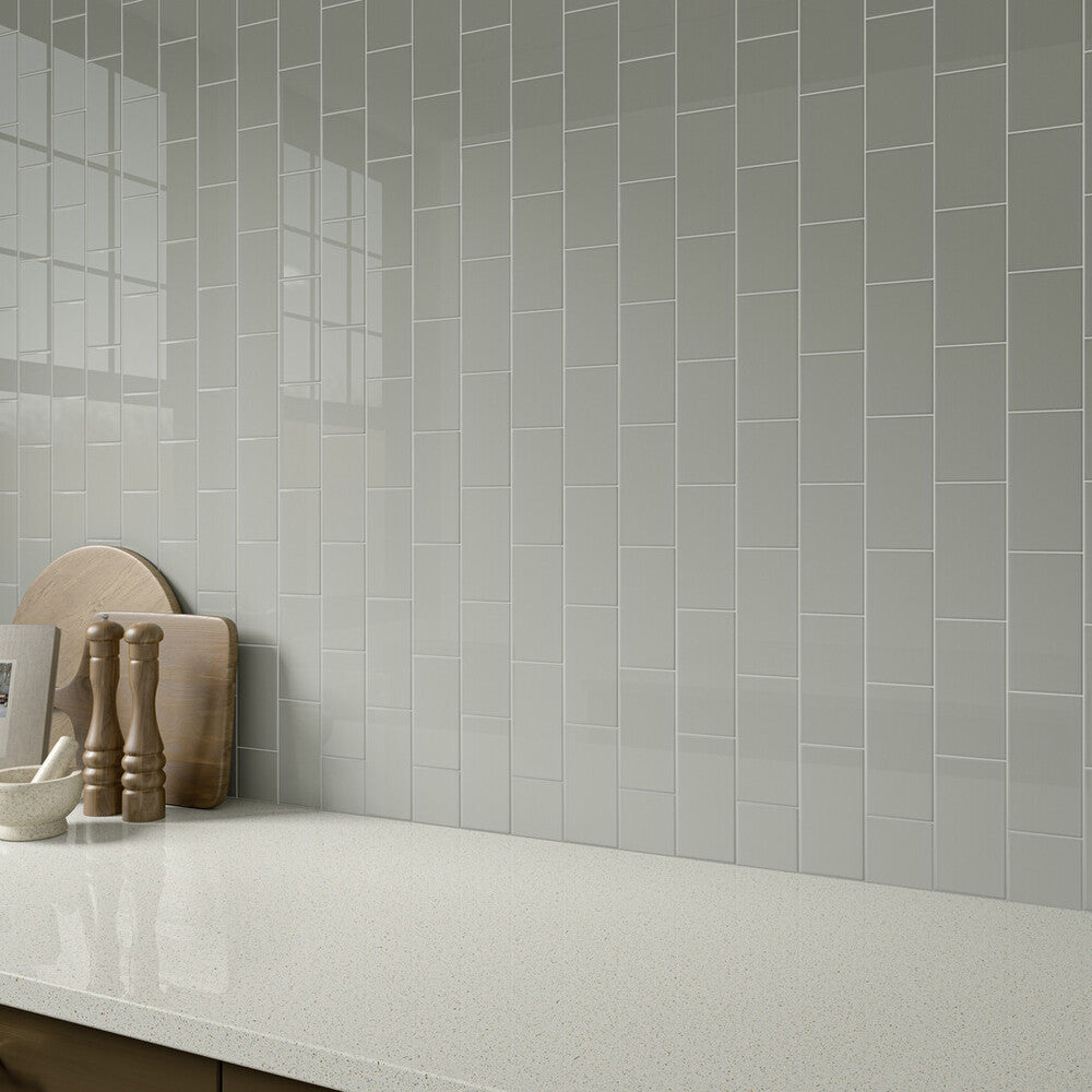 Styled with cool, earthy undertones, the Color Wheel Classic Desert Gray 3x6 glossy glazed ceramic tile is shown adding subtle depth and a sleek surface in this roomscene.