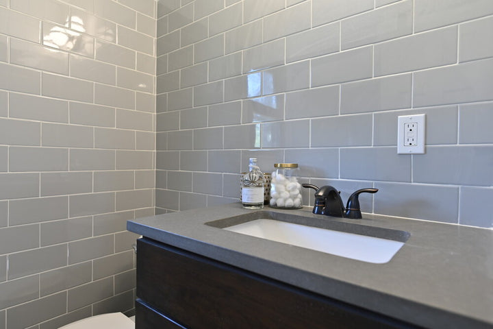 Displayed in a real-world setting, the Color Wheel Classic Desert Gray 3x6 glossy glazed ceramic tile introduces a soft neutral tone with a smooth surface