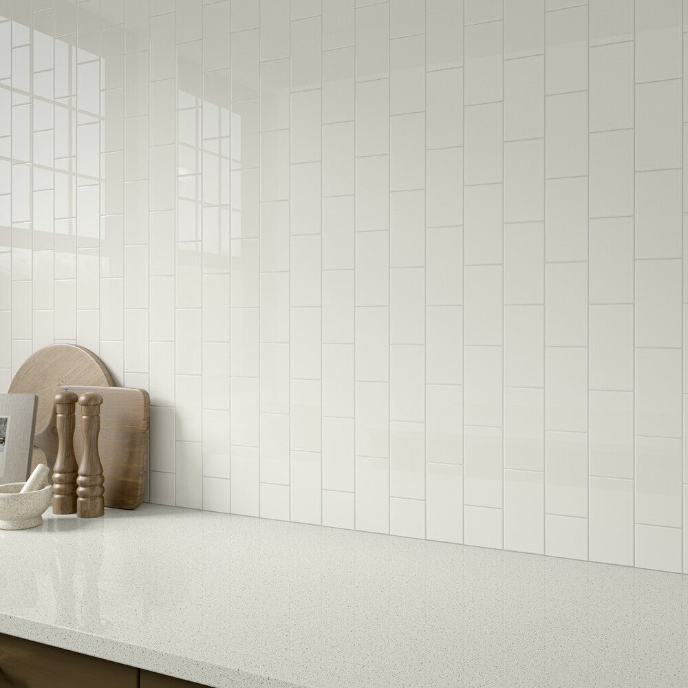 Here, Color Wheel Classic White 3x6 glossy glazed ceramic tile is featured with its bright tone and high-shine finish, lending a clean and modern feel to the space.