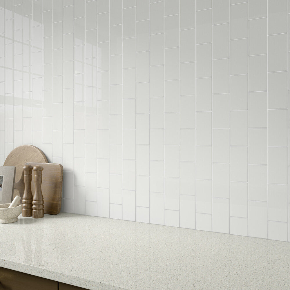 This roomscene highlights the brilliance of Color Wheel Classic Arctic White 3x6 glossy glazed ceramic tile, offering a vivid white hue with a polished aesthetic.