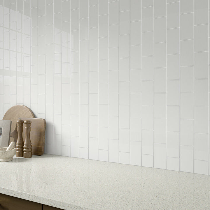 This roomscene highlights the brilliance of Color Wheel Classic Arctic White 3x6 glossy glazed ceramic tile, offering a vivid white hue with a polished aesthetic.