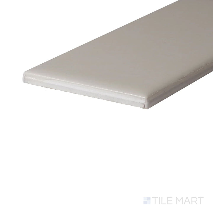 Side perspective of Color Wheel Classic Biscuit 3X6 Glossy Glazed Ceramic, capturing its soft neutral hue and glossy coating that enhances light reflection.