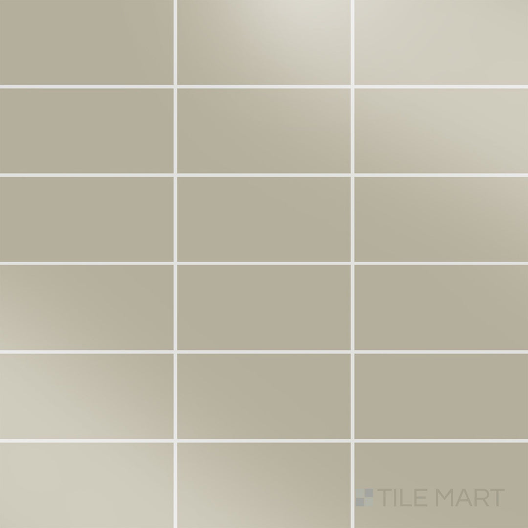 Captured from above, the Color Wheel Classic Architectural Gray 3x6 glossy glazed ceramic tile showcases a sleek, neutral gray shade with a reflective surface that enhances brightness.