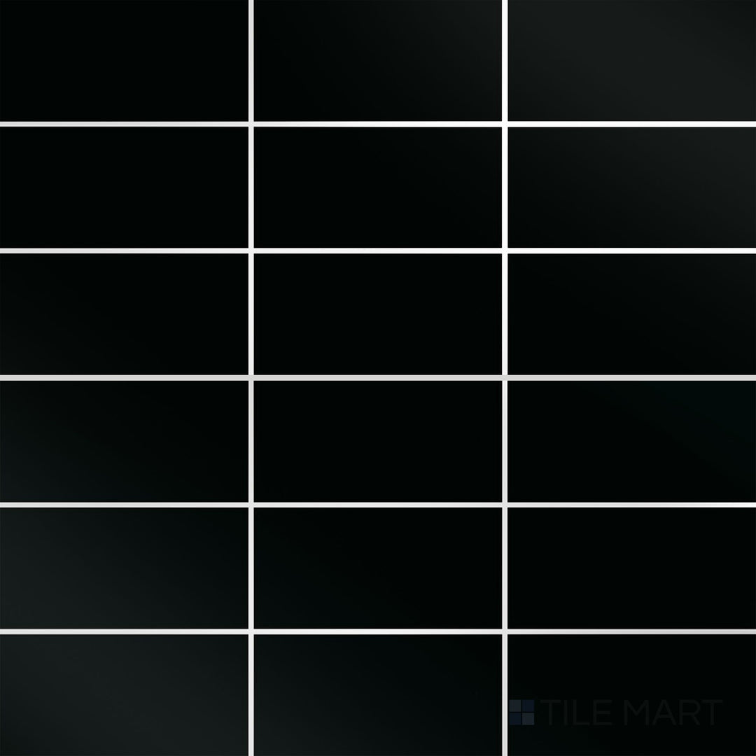 A top-down view of the Color Wheel Classic Black 3x6 glossy glazed ceramic tile reveals a deep black shade with a mirror-like finish, adding depth and sophistication to any design.