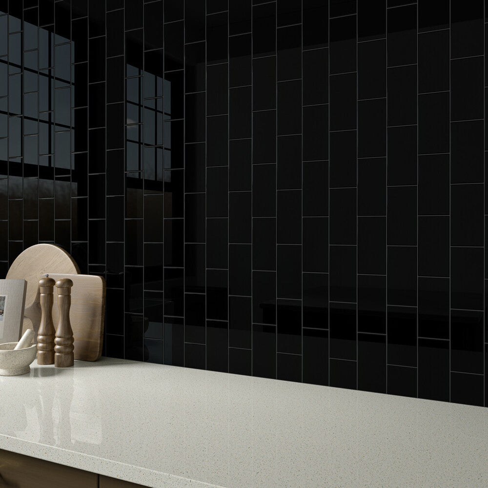 Color Wheel Classic Black 3x6 glossy glazed ceramic tile is featured in this roomscene with bold contrast and a reflective surface that enhances its dramatic appeal.