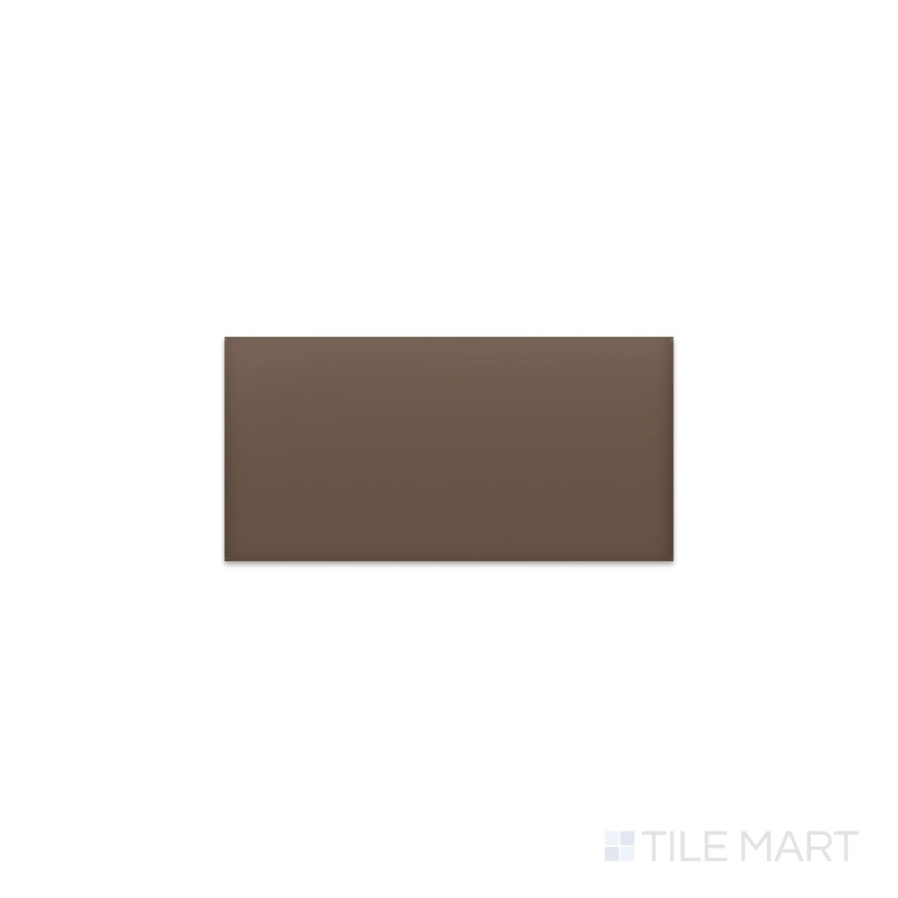 Slanted perspective of Color Wheel Classic Artisan Brown 3x6 matte glazed ceramic tile, emphasizing a warm earthy brown color, a velvety matte texture, and a sleek rectangular shape.  