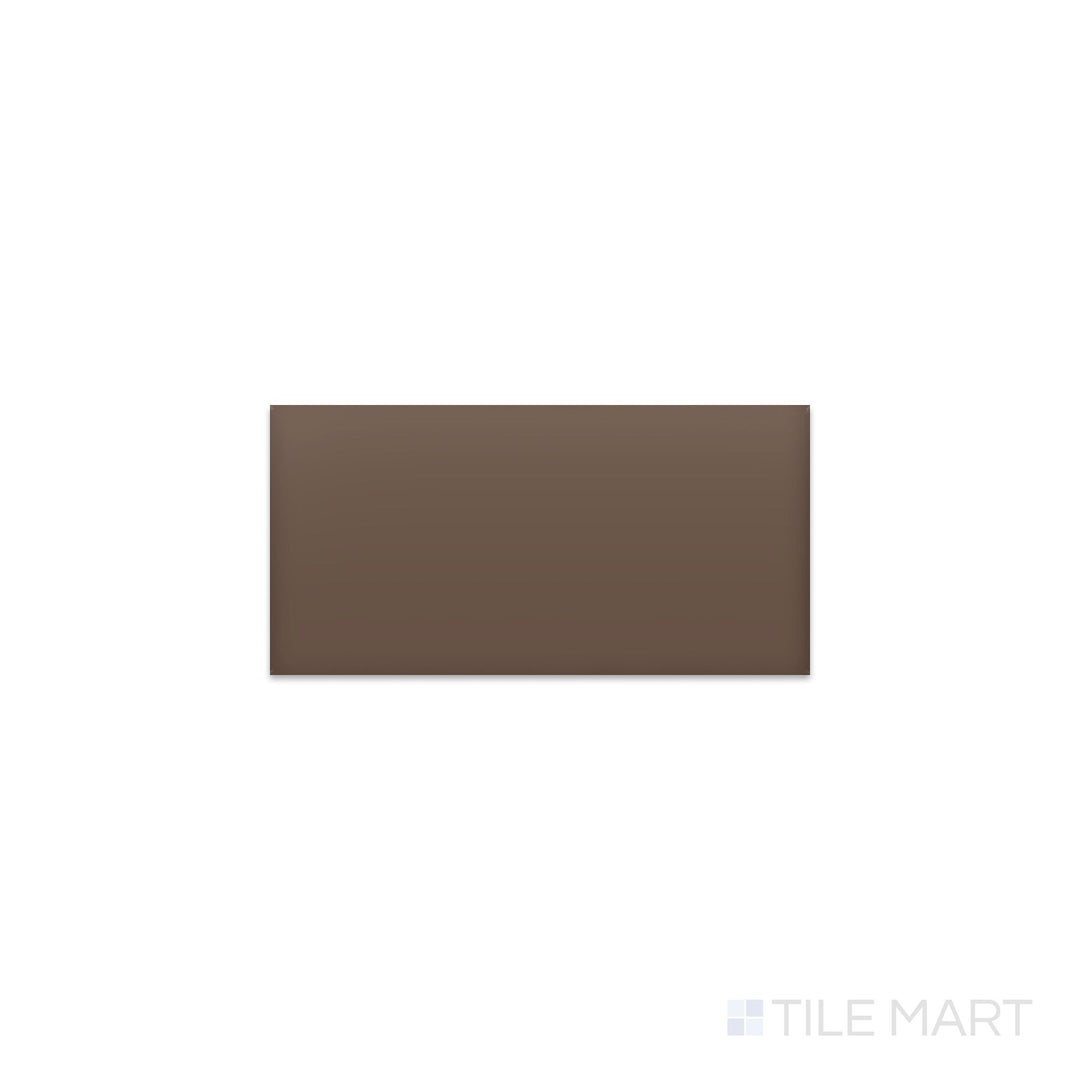 Slanted perspective of Color Wheel Classic Artisan Brown 3x6 matte glazed ceramic tile, emphasizing a warm earthy brown color, a velvety matte texture, and a sleek rectangular shape.  