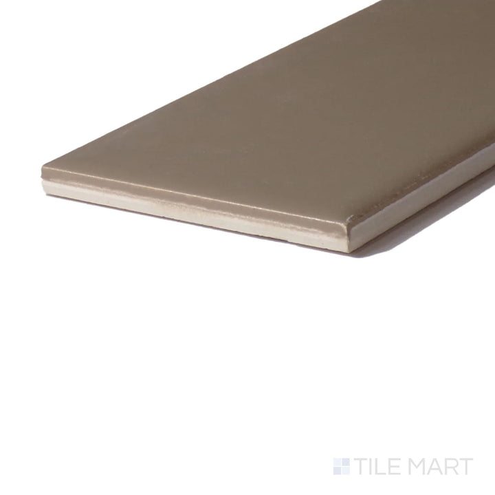 Angled view of Color Wheel Classic Elemental Tan 3X6 Matte Glazed Ceramic, capturing its warm, earthy tan hue with a muted, natural texture.