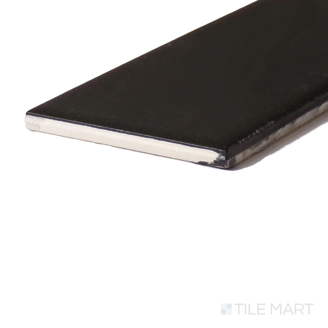 Angled close-up of Color Wheel Classic Black 3X6 Matte Glazed Ceramic, showcasing its deep, sophisticated black tone with a modern matte texture.