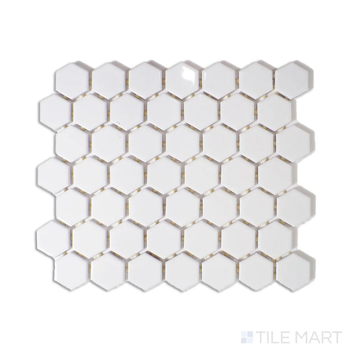 Angled shot of Color Wheel Mosaic Arctic White 1.5" hexagon glossy glazed ceramic tile, showcasing a crisp white tone with a reflective surface in a classic hexagonal pattern.  