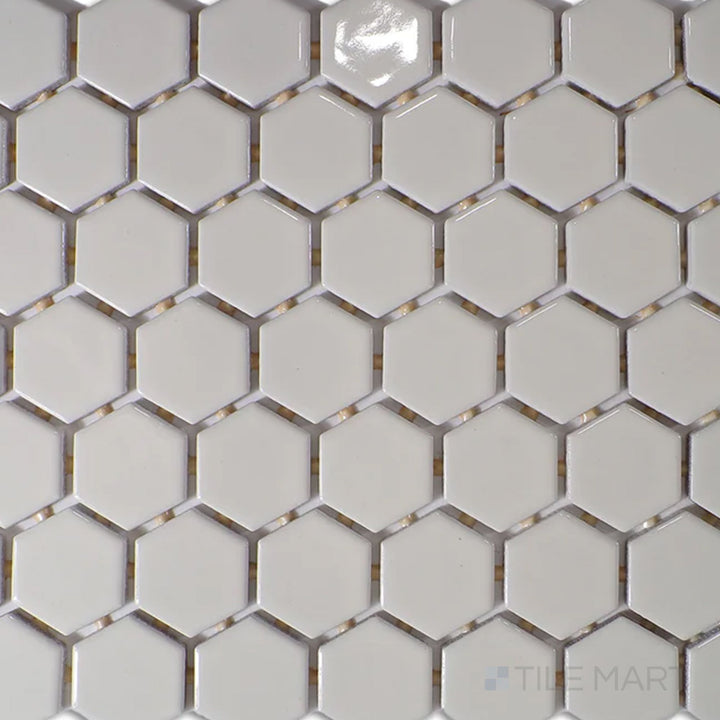 Captured from above, the Color Wheel Mosaic Biscuit 1.5" hexagon glossy glazed ceramic tile showcases a soft, warm beige tone with a lustrous surface, ideal for adding subtle elegance to any space.