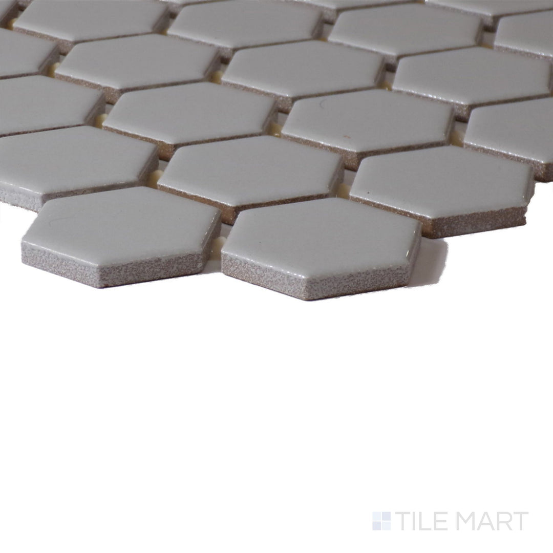 Close-up corner perspective of Color Wheel Mosaic Desert Gray 1.5" Hexagon Glossy Glazed Ceramic, showcasing its modern gray hue with a reflective glaze.