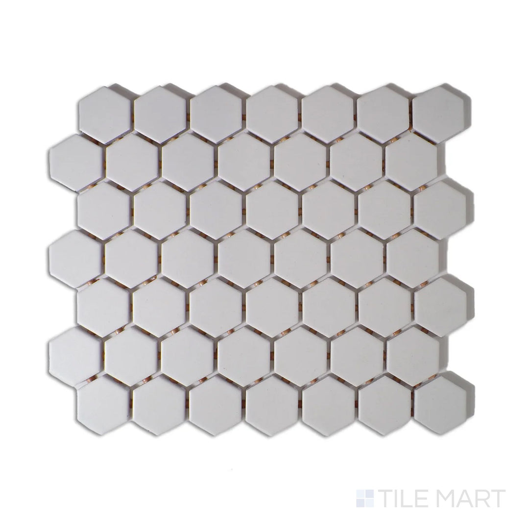 Angled shot of Color Wheel Mosaic Arctic White 1.5" hexagon matte glazed ceramic tile, showcasing a bright white shade with a smooth, non-reflective surface in a timeless hexagonal design.  