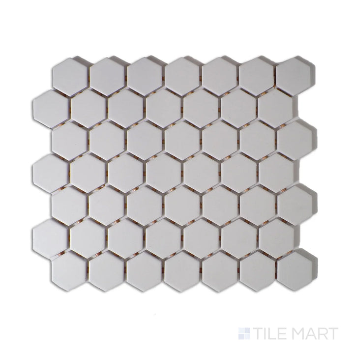 Angled shot of Color Wheel Mosaic Arctic White 1.5" hexagon matte glazed ceramic tile, showcasing a bright white shade with a smooth, non-reflective surface in a timeless hexagonal design.  