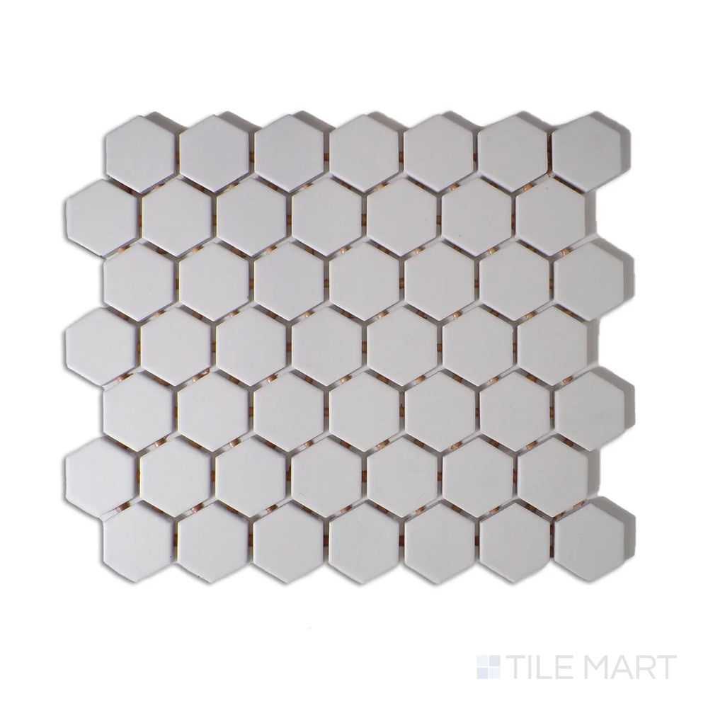 Angled shot of Color Wheel Mosaic Arctic White 1.5" hexagon matte glazed ceramic tile, showcasing a bright white shade with a smooth, non-reflective surface in a timeless hexagonal design.  