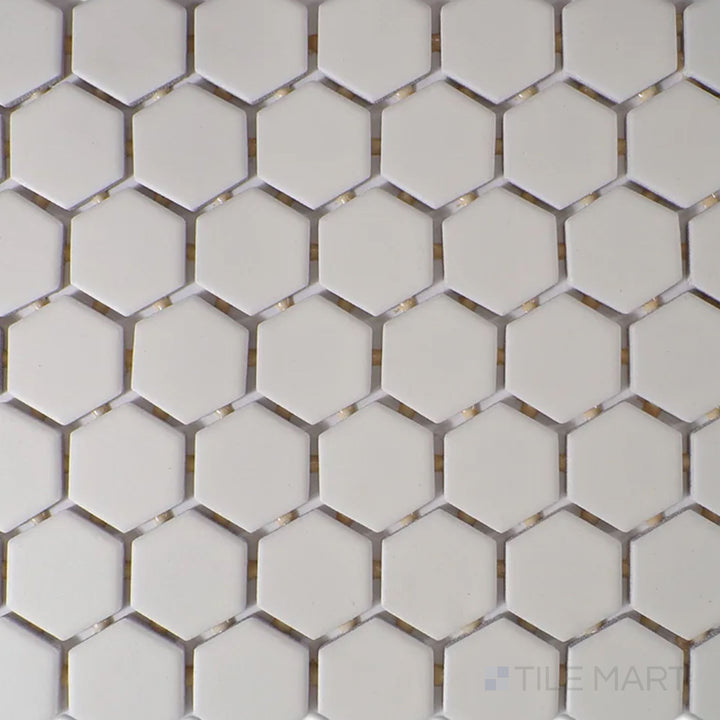 A top-down view of the Color Wheel Mosaic Biscuit 1.5" hexagon matte glazed ceramic tile showcases a soft beige hue with a smooth, non-glossy finish, adding warmth to contemporary and classic spaces.