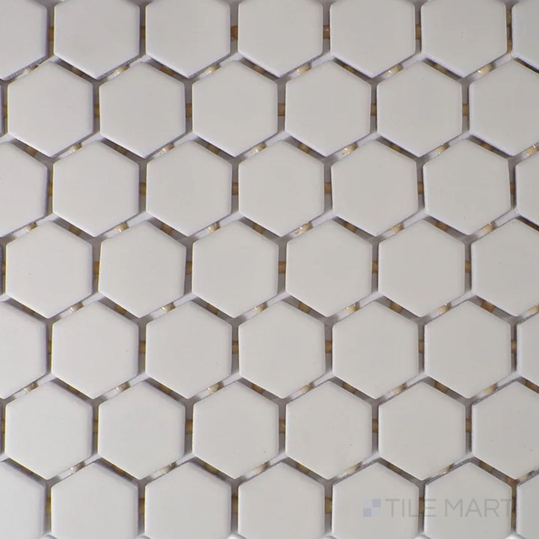 A top-down view of the Color Wheel Mosaic Biscuit 1.5" hexagon matte glazed ceramic tile showcases a soft beige hue with a smooth, non-glossy finish, adding warmth to contemporary and classic spaces.