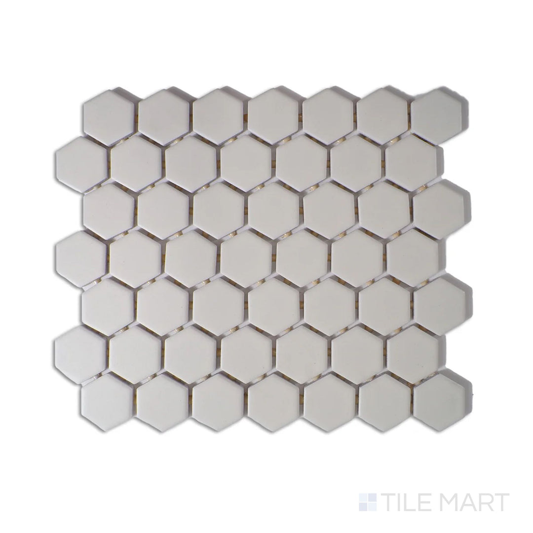 Diagonal view of Color Wheel Mosaic Biscuit 1.5" hexagon matte glazed ceramic tile, featuring a soft beige tone with a matte finish in a structured hexagonal arrangement.  