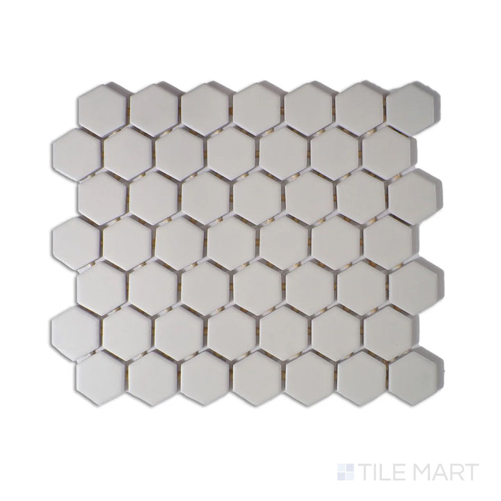 Diagonal view of Color Wheel Mosaic Biscuit 1.5" hexagon matte glazed ceramic tile, featuring a soft beige tone with a matte finish in a structured hexagonal arrangement.  