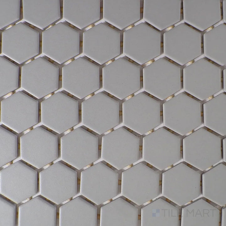 Captured from above, the Color Wheel Mosaic Desert Gray 1.5" hexagon matte glazed ceramic tile features a versatile gray tone with a soft matte surface, perfect for modern and industrial aesthetics.