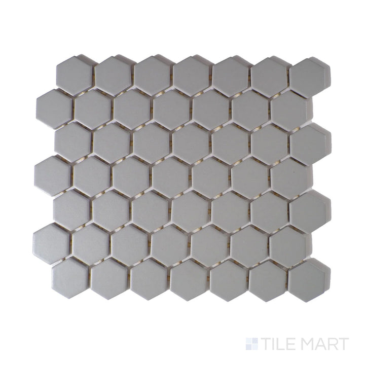 Slanted perspective of Color Wheel Mosaic Desert Gray 1.5" hexagon matte glazed ceramic tile, emphasizing a cool gray tone with a non-reflective texture in a geometric hexagonal layout.  