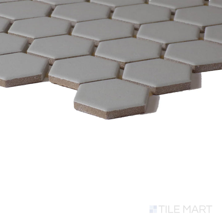 Close-up corner perspective of Color Wheel Mosaic Desert Gray 1.5" Hexagon Matte Glazed Ceramic, showcasing its neutral gray hue with a natural matte surface.