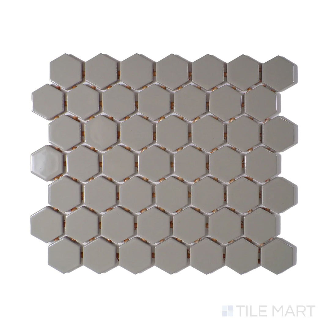Angled shot of Color Wheel Mosaic Architectural Gray 1.5" hexagon glossy glazed ceramic tile, showcasing a soft gray tone with a glossy finish in a modern hexagonal arrangement.  