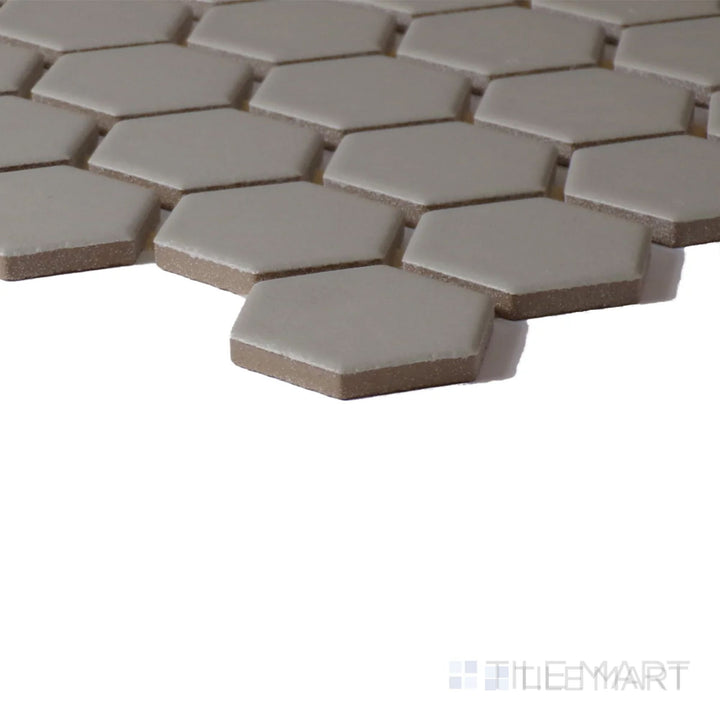 Side perspective of Color Wheel Mosaic Architectural Gray 1.5" Hexagon Glossy Glazed Ceramic, highlighting its structured hexagon layout and glossy surface.