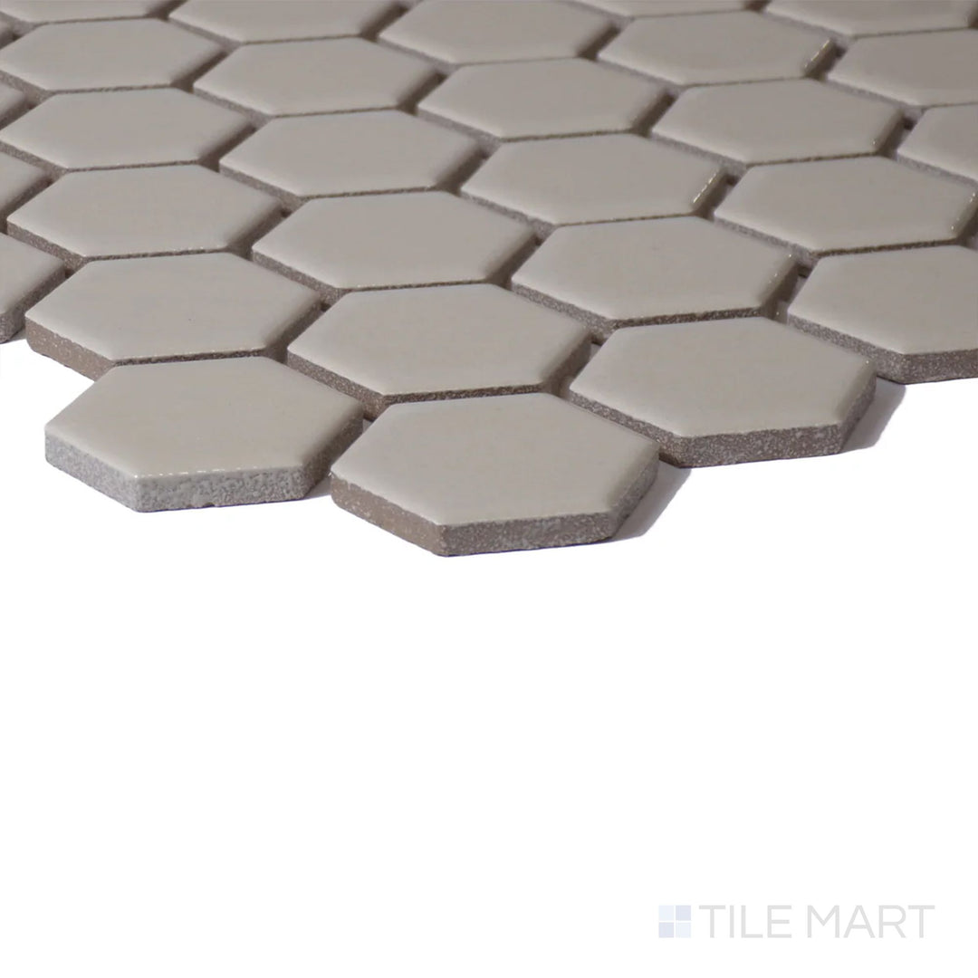 Corner shot of Color Wheel Mosaic Urban Putty 1.5" Hexagon Glossy Glazed Ceramic, featuring a warm, neutral shade with a bright, polished look.