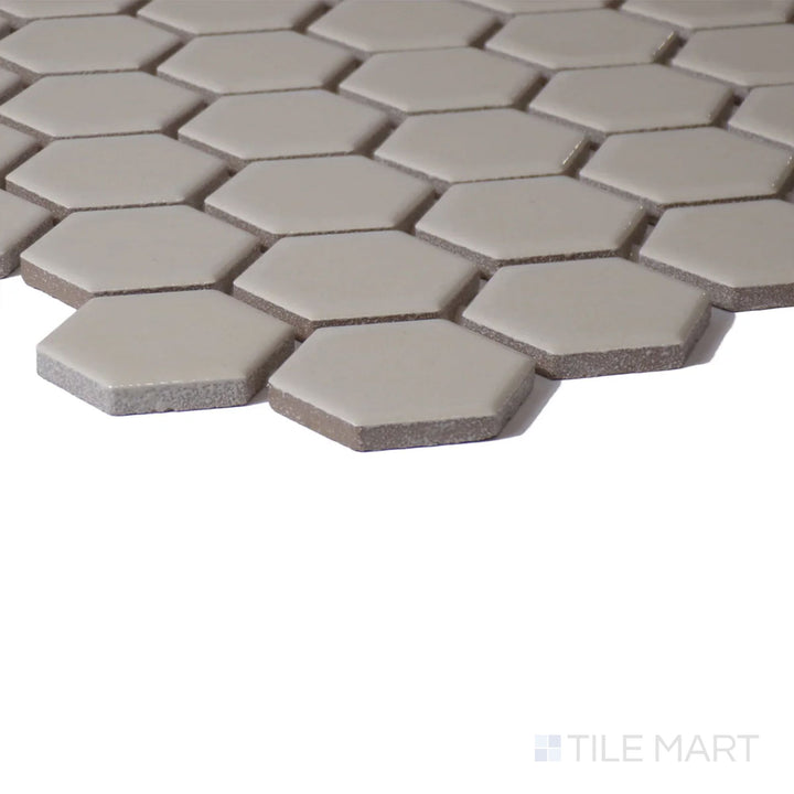 Corner shot of Color Wheel Mosaic Urban Putty 1.5" Hexagon Glossy Glazed Ceramic, featuring a warm, neutral shade with a bright, polished look.