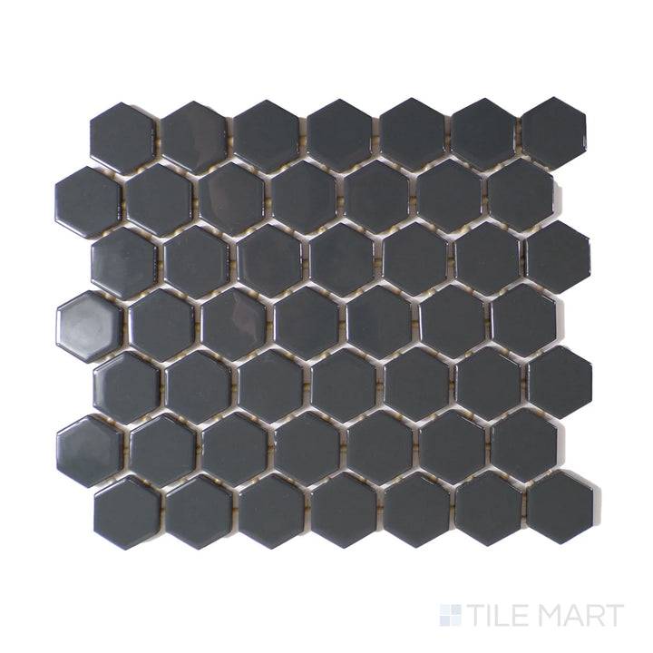 Slanted perspective of Color Wheel Mosaic Chalkboard 1.5" hexagon glossy glazed ceramic tile, emphasizing a deep black hue with a reflective finish and a sleek hexagonal pattern.  