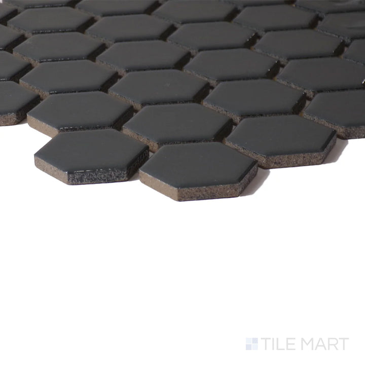 Angled close-up of Color Wheel Mosaic Chalkboard 1.5" Hexagon Glossy Glazed Ceramic, showcasing its deep black shade and high-gloss reflection.